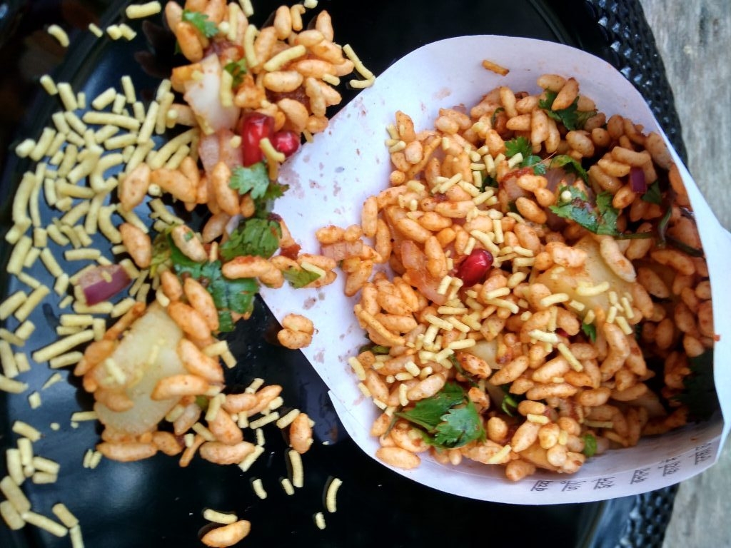Bhelpuri is a savoury snack common in Maharashtra.It is a mixture of puffed rice, chopped onions,chopped tomatoes,tamarind chutney. Bhelpuri can be served in a lot of ways, but usually it is served on a paper which is folded in the form of a cone and is consumed using a paper spoon.